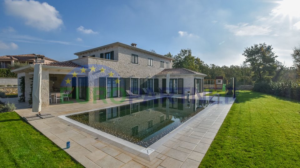 A modern villa with a swimming pool and a large garden